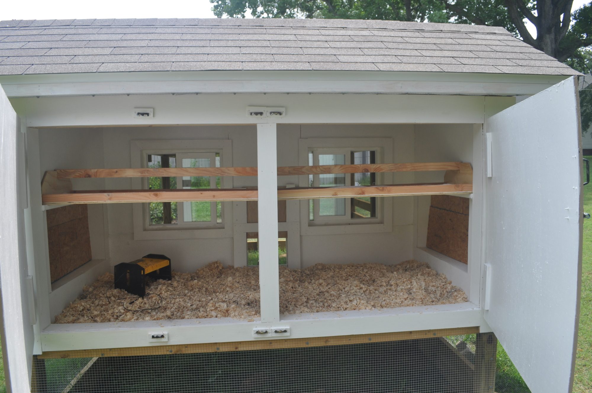 Doors open showing the windows and the roosts/poop catchers.